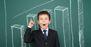 image of student in front of chalkboard bar graph